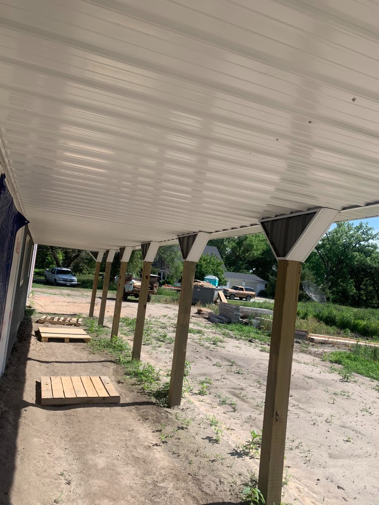 Covered porch run: wood posts and white metal porch ceiling