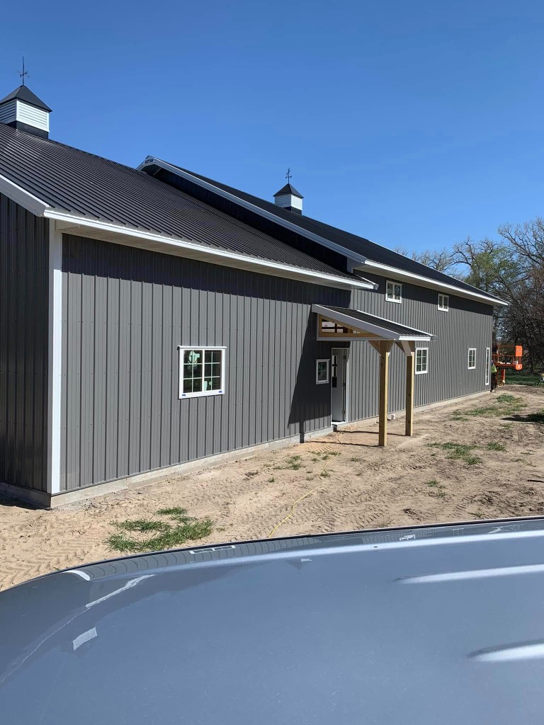 Side elevation: long façade with cupolas and overhead door bay