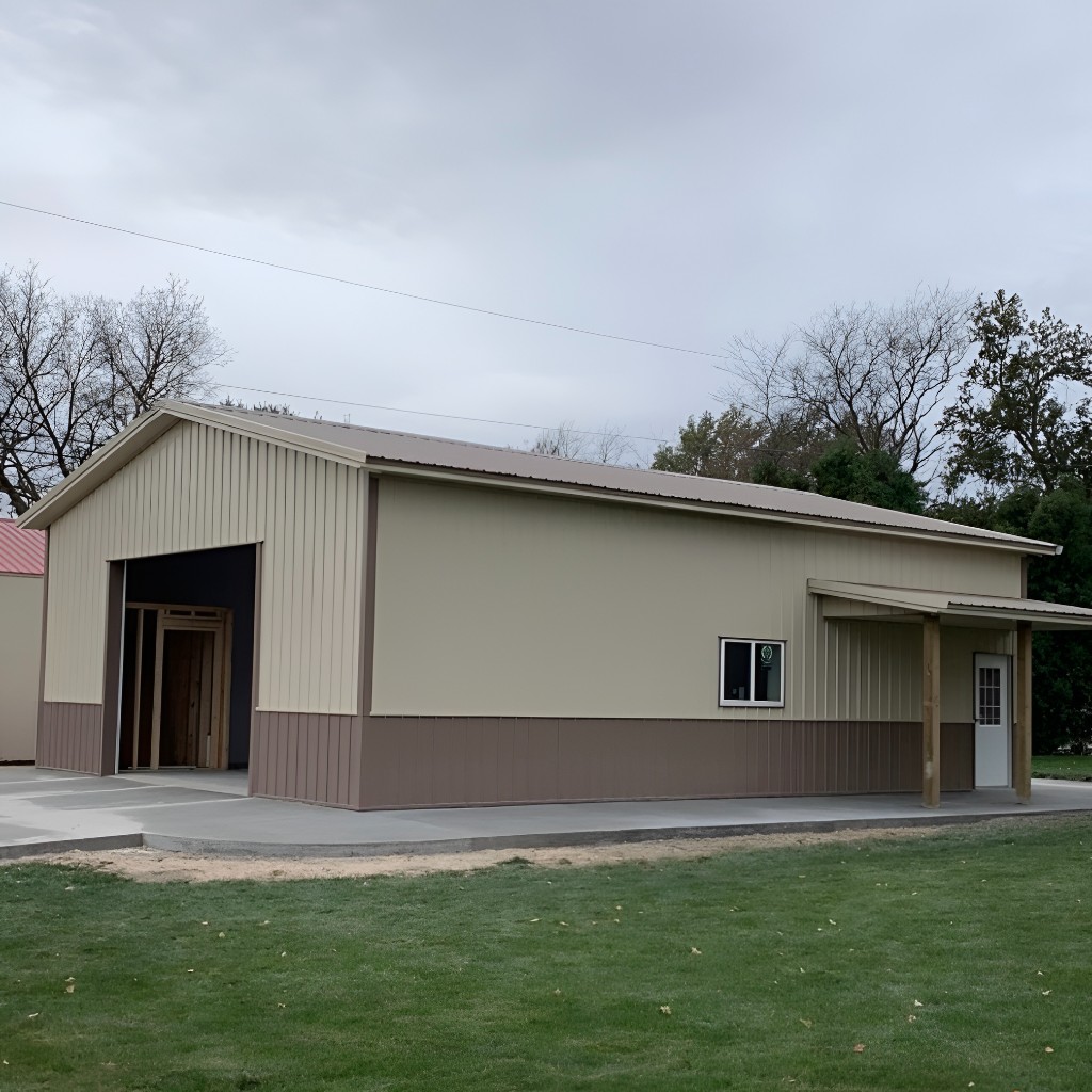 Tan and brown two-tone metal workshop with gable roof, overhead door bay, side window, and wood-post porch entry on concrete—Nebraska.